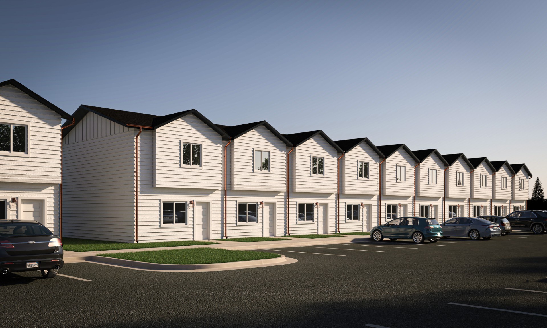 A row of houses with cars parked in front.